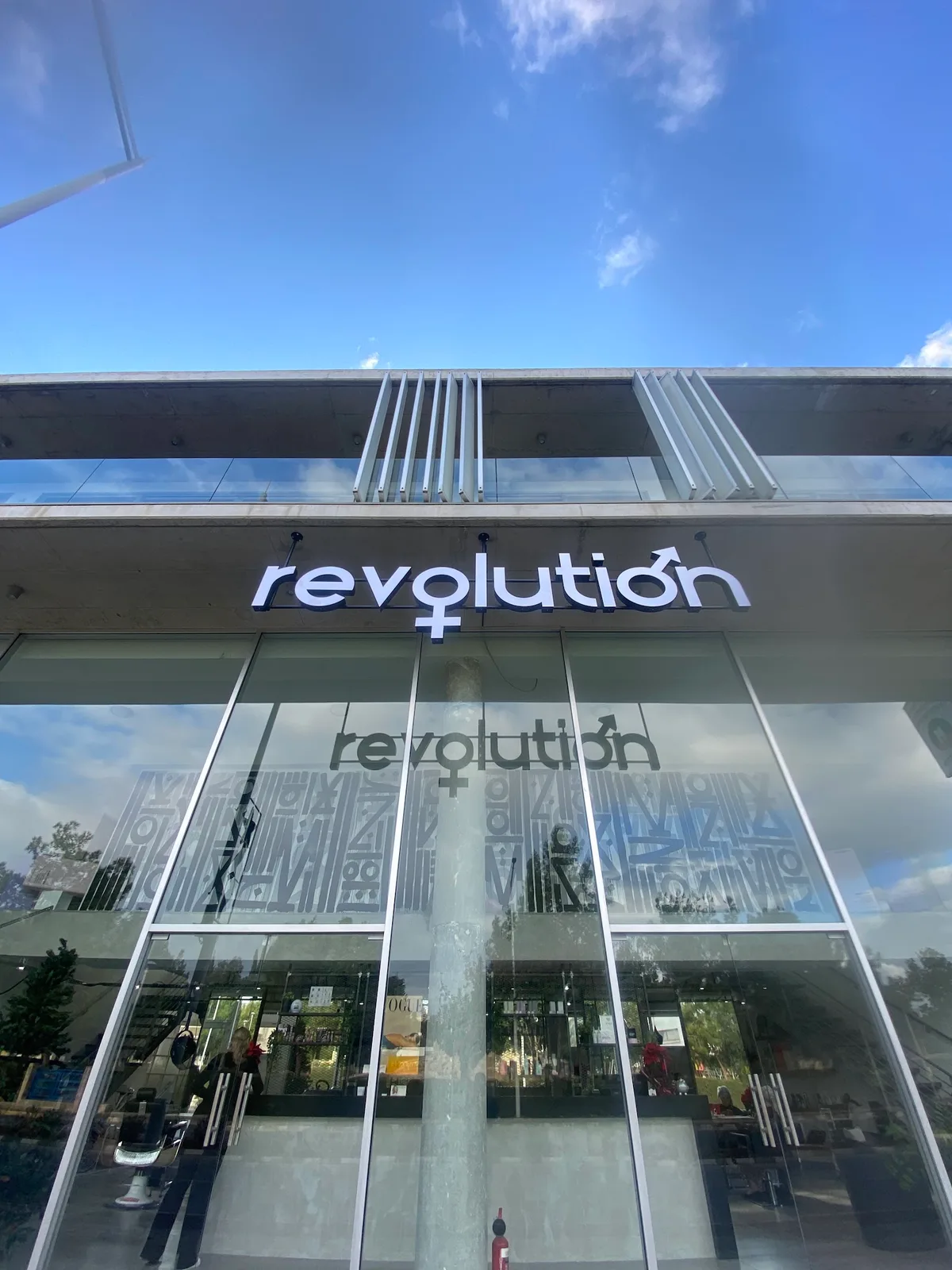 The Revolution salon front with its illuminated sign on Alexandrou Ypsilanti street in Paphos